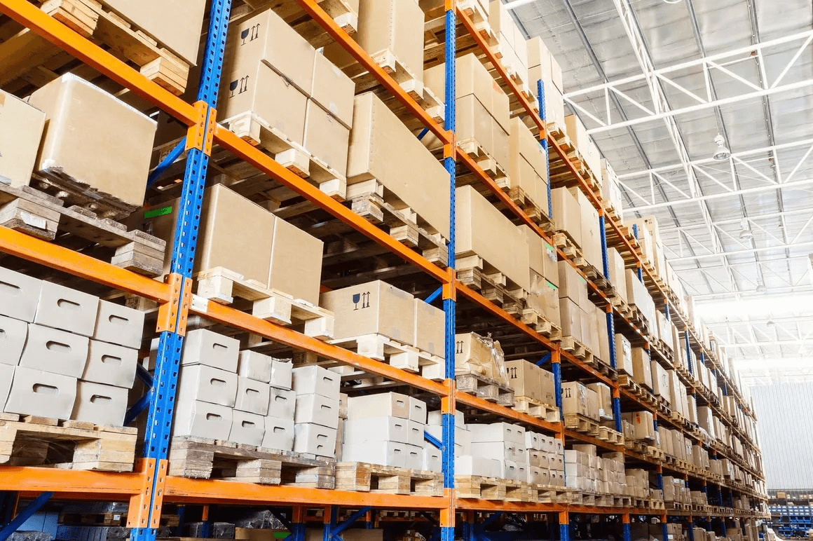 Long warehouse aisle stocked with palletised inventory